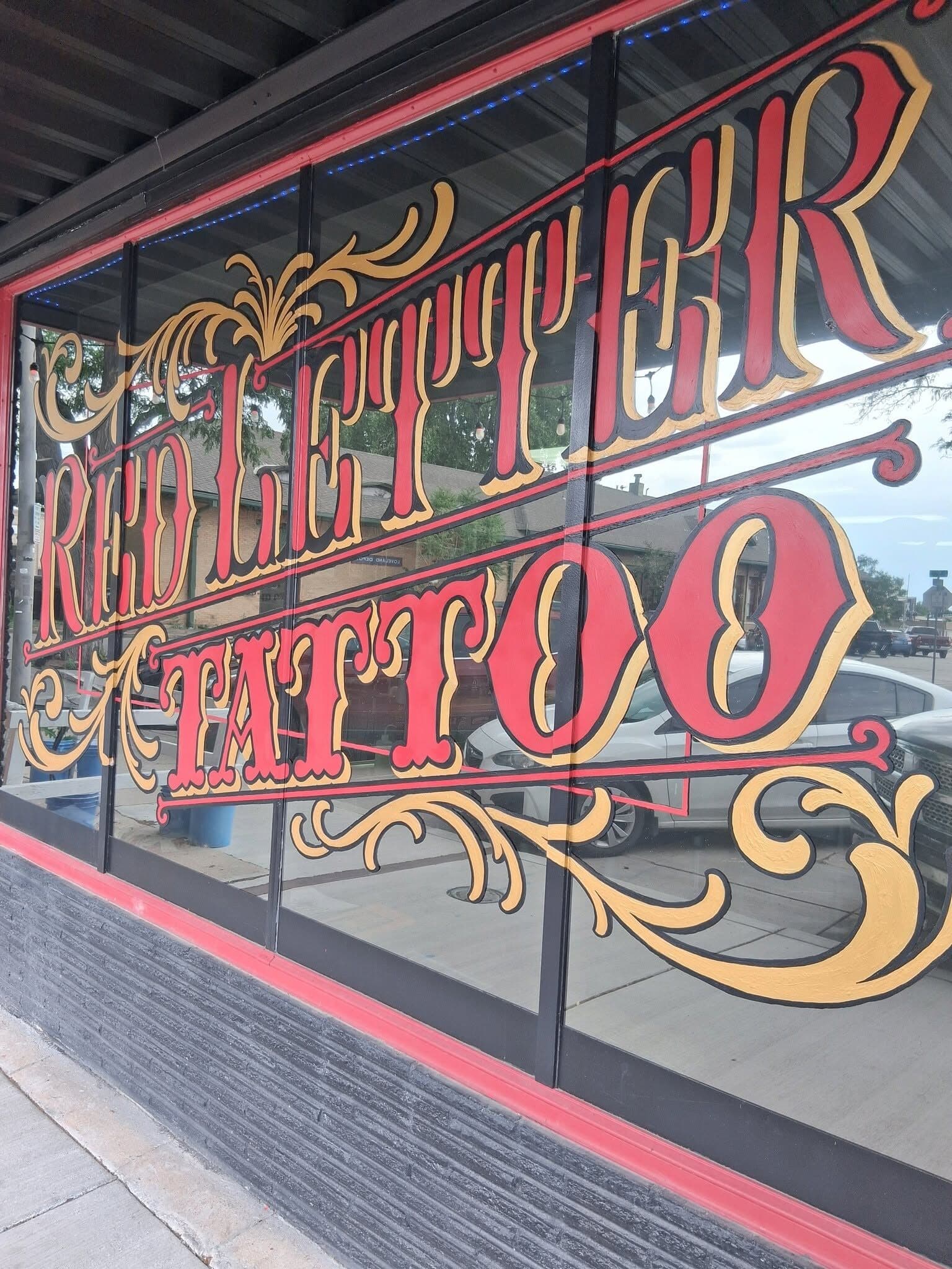 Hand-painted Red Letter Tattoo window sign in red and gold