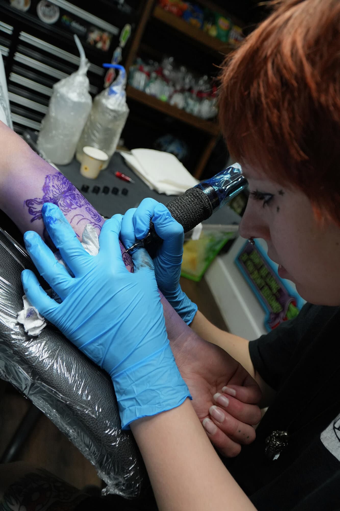 Ava Brady tattooing a stipple piece on a client's forearm