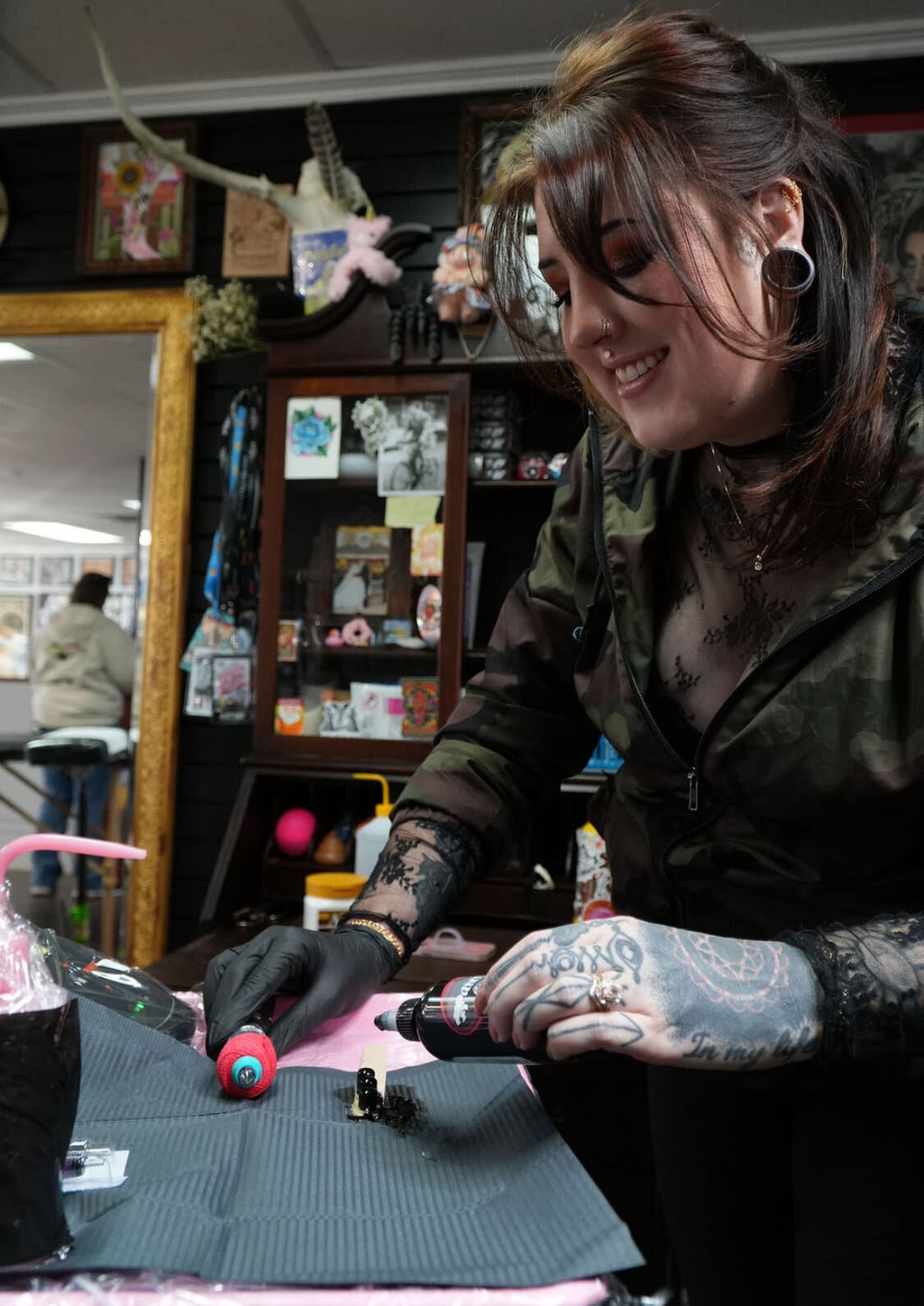 Shannon Vagott prepping ink at her station at Red Letter Tattoo