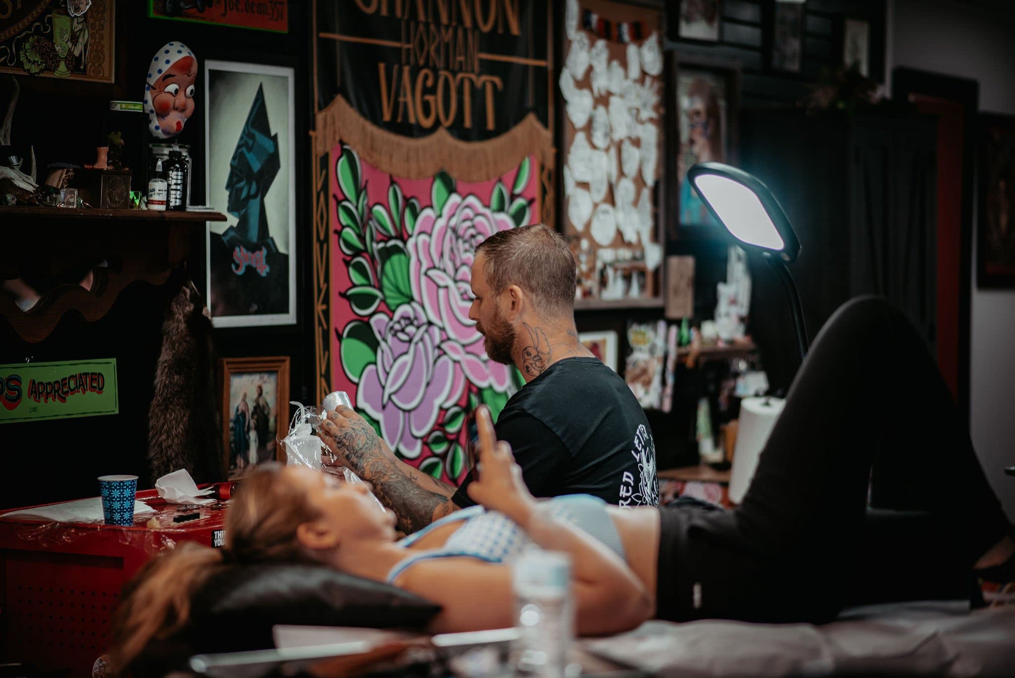 Artist tattooing a client at Red Letter Tattoo