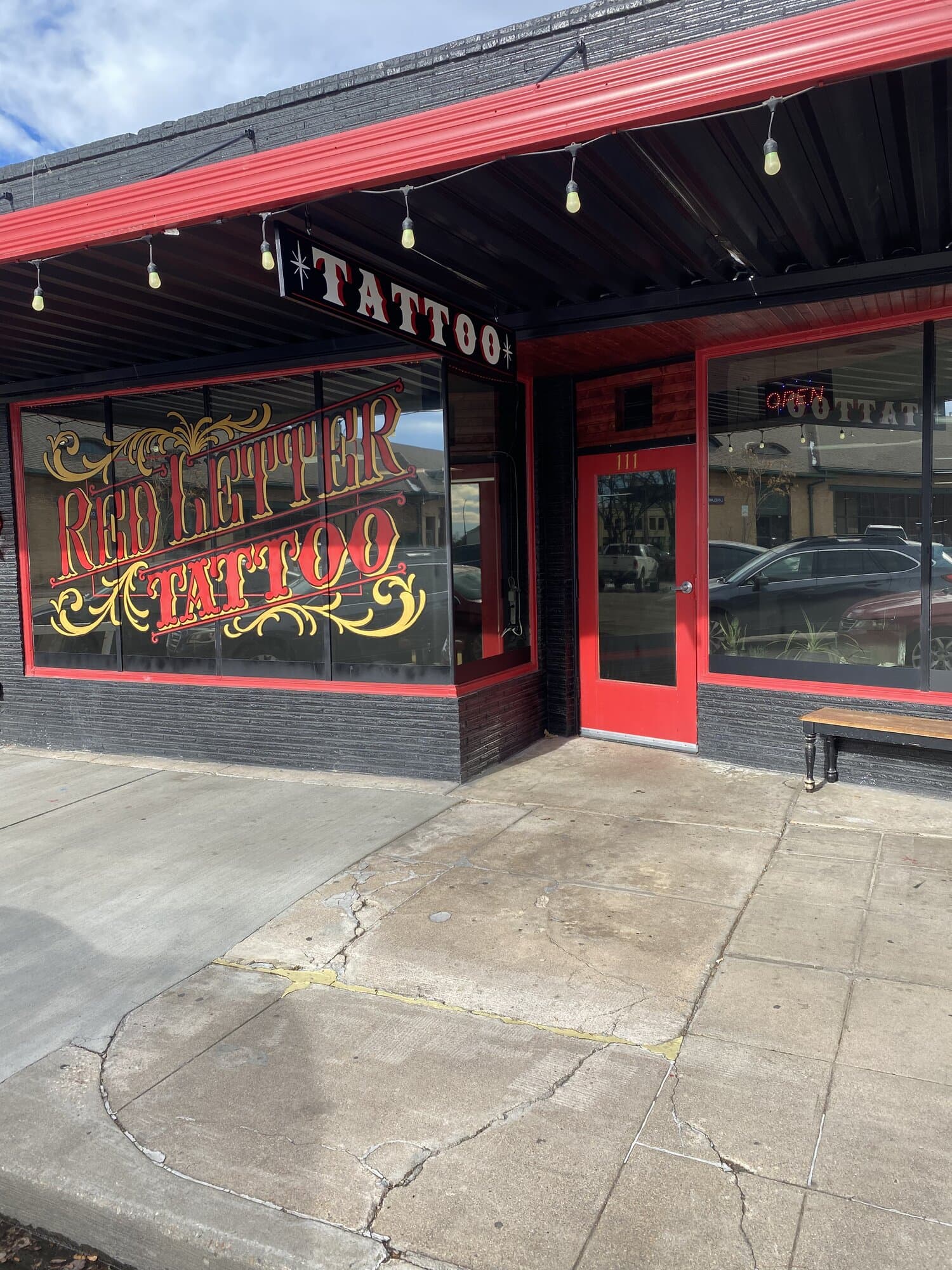 Red Letter Tattoo storefront and red entry door on Fifth Street