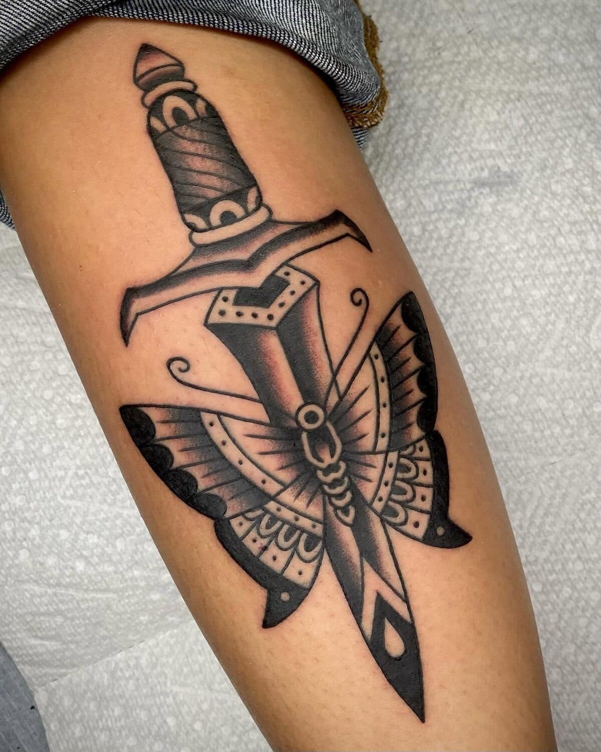 Dagger through a butterfly, traditional black and gray linework