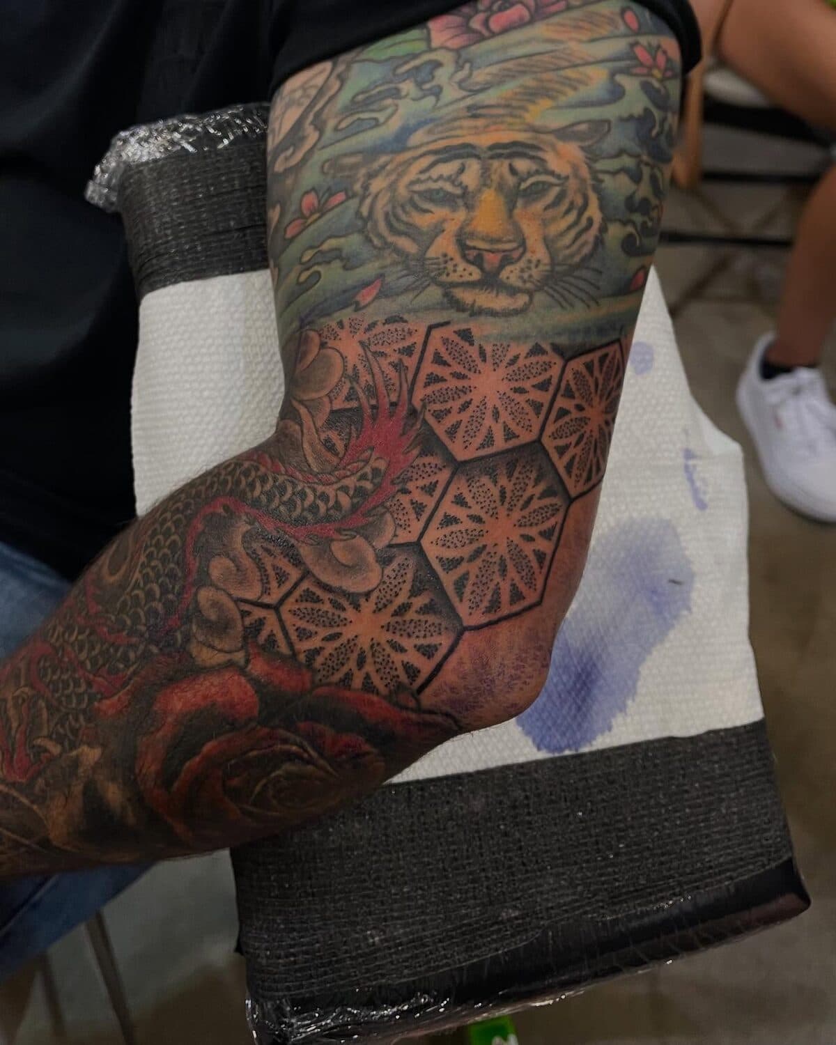 Colorful tiger head and citrus-slice tattoo